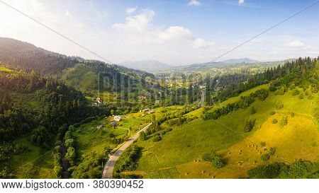Scenic Panoramic Landscape. Aerial Drone View Of Picturesque Urban-type Settlement In Valley Among G