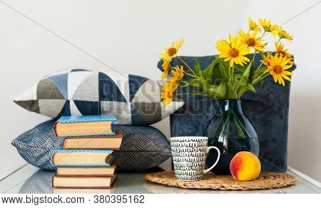 Cozy Home Interior Decor: Stack Of Books, Peach, Cup Of Coffe, Decorative Pillows, Box With Plaid An