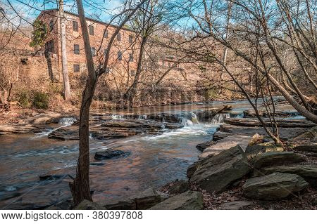 Big Creek Flowing With Small Waterfalls Downstream Alongside The Old Mill Park In Roswell Georgia On