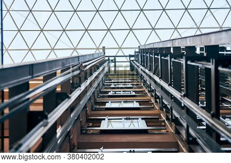 Open Elevator Lift Shaft. Modern Architecture With Transparent Ceiling. Shopping Mall Or Business Ce