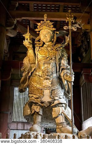 Nara, Japan - 13 June 2016: Tamonten Bishamonten, Guardian of the North, one of the Shitenno or Guardians of the Four Directions, an ancient wooden sculpture at the Todaiji Temple, Nara, Japan