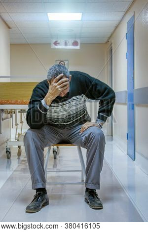 relative of a patient grieving in the hospital hallway