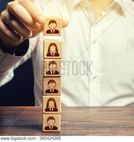 Business Leader Builds A People Block Tower. Definition Of People In A Hierarchical System. Meritocr