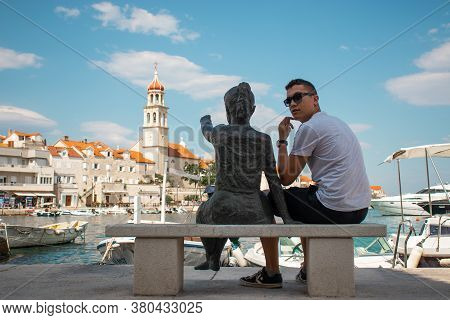 Sutivan, Croatia August 2020 Statue Of A Little Girl Pointing At The Belltower In A Small Village Of