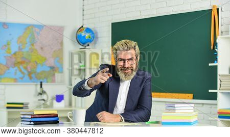 Knowledge Day. Man School Teacher Sit In Classroom. Handsome Mature Smart Educator. Ensure Suitabili