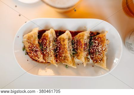 Top View On Cooked Japanese Gedza Dumplings With Soy Sauce