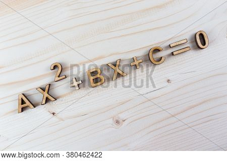Abstract Illustration With Quadratic Equation From Laser-cut Plywood On Wooden Background
