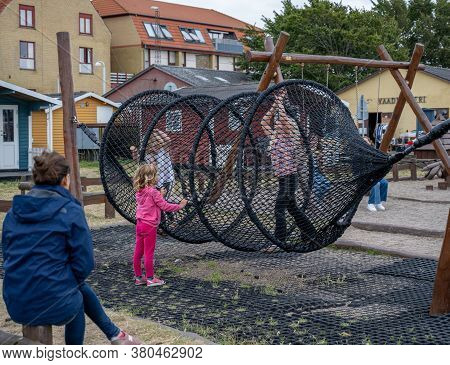 Hundested, Denmark - August 2, 2020: Children Play In A Playground. It Is Plenty Of Tourism Activiti