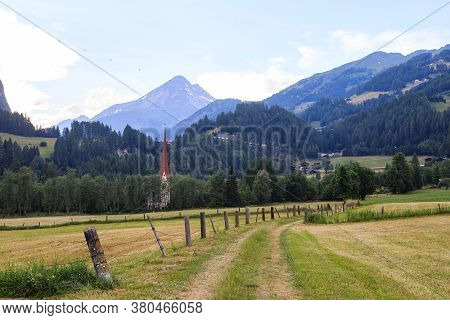 Rural Alpine Landscape With Church Of St. Martin In Pockhorn Near Heiligenblut In Hohe Tauern Nation