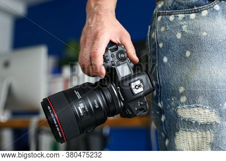 Barcelona, Spain - July 31, 2020: Male Hand Holding Brand New Mirrorless Digital Camera Canon R5 Clo