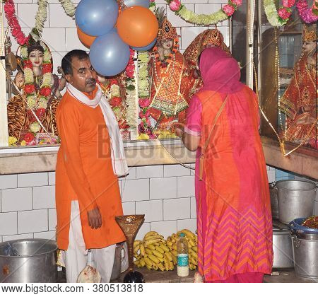 Delhi - India
Aug 12th 2020
A Hindu Priest Watches While A Female Devotee Is Performing Pooja During