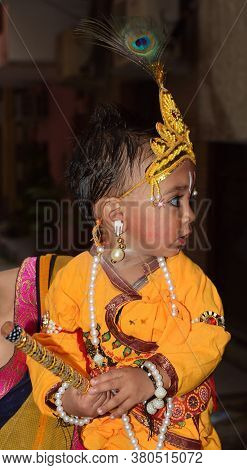 Delhi - India
Aug 12th 2020
Side Angles Shot Of  Indian Child  Dressed As Lord Krishna On Occasion O