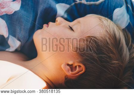 Cute Little Boy Sleep Sweetly On Pillow With Bright Morning Sunbeams From Window, Taking A Nap. Happ
