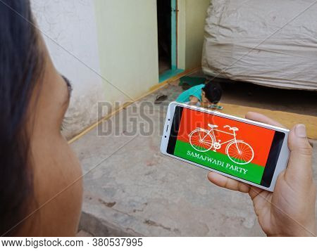 District Katni, India - 28 May 2020: An Indian Lady Holding Smart Phone With Displaying Samajwadi Pa