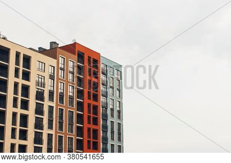 Fragment Of Modern Residental Building Exterior In The Daylight - Against Grey Sky As Background Wit
