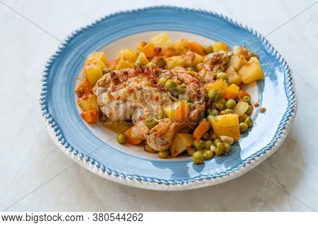 Chicken Thighs With Potato, Carrot And Green Peas Served In Plate For One Portion