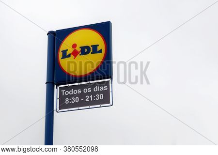 Torres Vedras, Portugal - August 12, 2020: Logo Sign Lidl And Opening Hours . Lidl Stiftung & Co. Kg