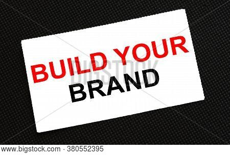 White Card On The Black Background With Text Build Your Brand