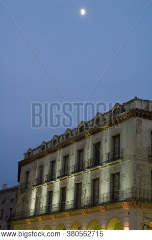 Building and moon at sunset. Lopez Allue square. Huesca. Aragon Spain.