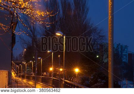Illuminated street lamps on a street in Sabinanigo at nightfall. Huesca. Aragon. Spain.