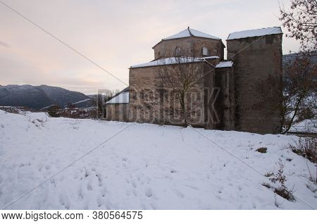 Church in a snow-covered rural landscape. Sabinanigo Alto. Huesca. Aragon. Spain.