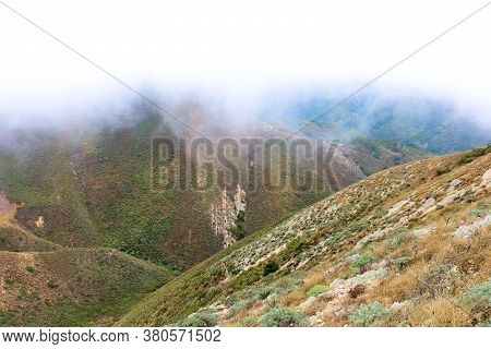 Fog And Low Marine Clouds Covering Barren Coastal Mountains Taken On Windswept Valencia Peak At The 