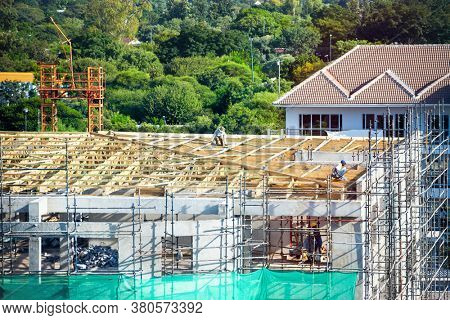 African workers working on a multistory construction site in the capital city of Botswana, Gaborone