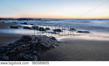 Amazingly Beautiful Winter Sea Coast At Sunset, Curved Coast Line With Forest In The Background, Bea