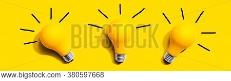 Three Yellow Light Bulbs - Flat Lay From Above