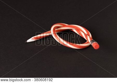 Flexible Pencil On A Dark Background. Selective Focus