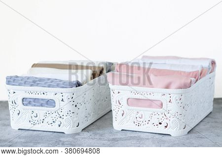 Clothing Neatly Folded By Method Vertical Storage Konmari. Two Organizer Boxes With Pastel Color Clo