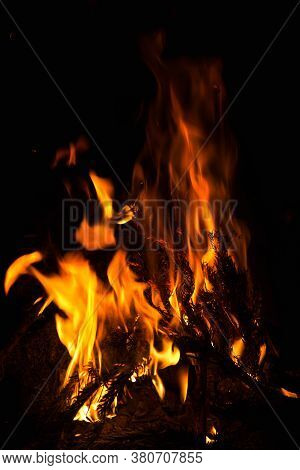 Dark Background Bonfire From Branches In The Fireplace .