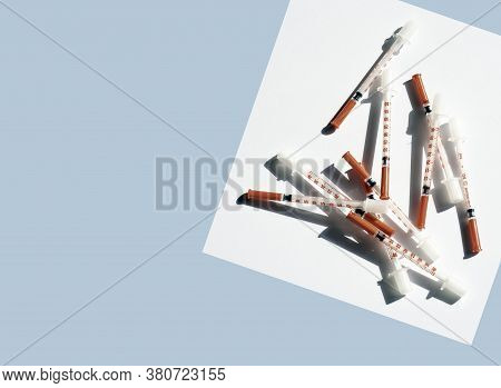 Medical Syringe From Diabetic Therapy. Clouse Up Of Syringe On White And Blue Background