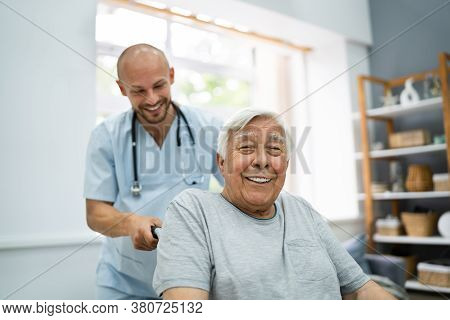 Senior Healthcare Caregiver And Happy Elder Patient