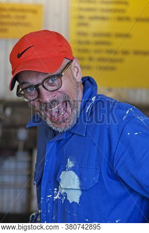 Umea, Norrland Sweden - June 26, 2020: A Man In A Blue Suit Who Messes Around In The Car Wash
