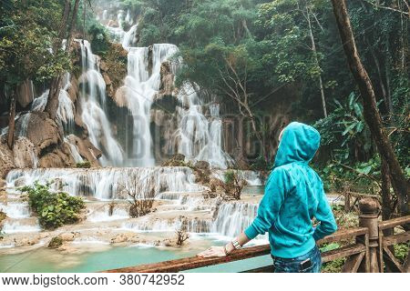 Tourist Girl Enjoy In Kuang Si Waterfall, Luang Prabang, Laos. Young Woman Have Fun And Happy Sights