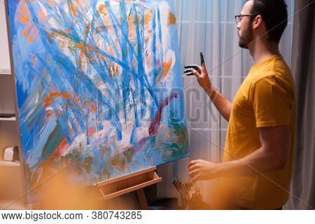 Young Artist Standing In Front Of Painting In Art Workshop. Painting A Masterpiece. Modern Artwork P