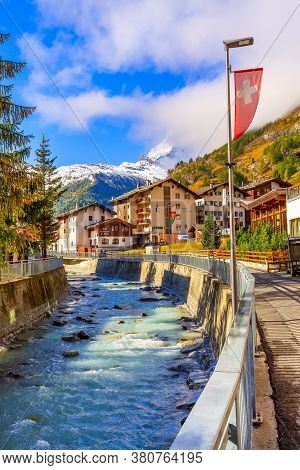 Zermatt, Switzerland - October 7, 2019: Town Street View In Famous Swiss Alps Ski Resort, River, Mat