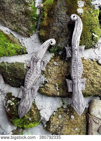 Pulau Samosir, Lake Toba, Sumatra, Indonesia, January 13, 2018: Salamander-shaped Wood Carvings On T