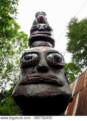 Pulau Samosir, Lake Toba, Sumatra, Indonesia, January 13, 2018: Toten Wood Carving Depicting Heads I