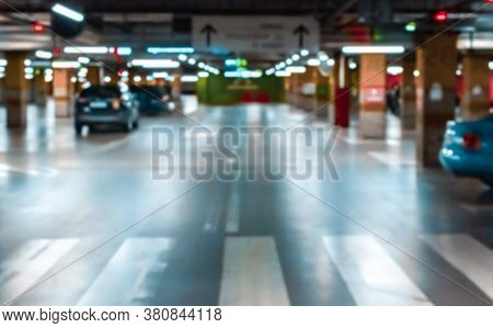 Rent Parking Space Blurred. Car Lot Parking Space In Underground City Garage. Empty Road Asphalt Bac