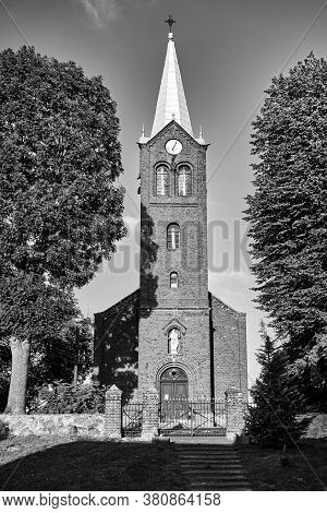 The Tower Of The Historic, Neo-gothic Red Brick Church In The Village Of Sokola Dabrowa In Poland, B