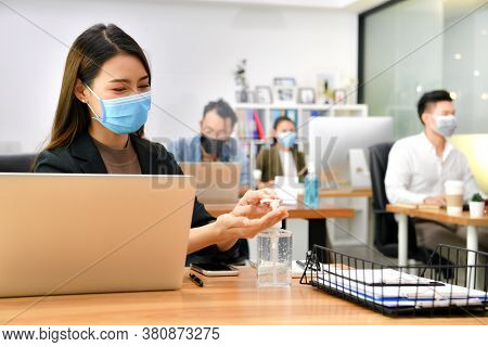Asian Woman Washing Hands Sanitizer Gel And Wearing Face Mask Working In New Normal Office And Doing