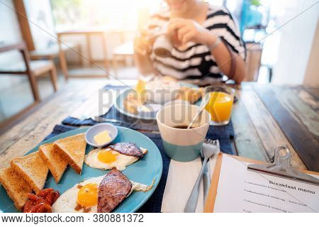 Woman Guest Enjoy Her Breakfast Manu In Restaurant Inside Her Hotel, This Image Can Use For Food, Ho