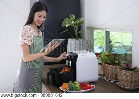 Asian Wife Made Oilless Air Fryer Machine For Cooking A Fried Chicken For Today Dinner, This Image C