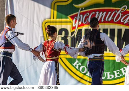 Young Men And Girls Dancing Serbian Traditional National Folk Dance Kolo