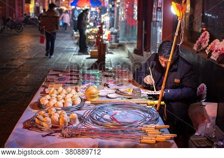Luoyang, Henan Province / China - January 3, 2016: Man Making And Selling Traditional Handicrafts In