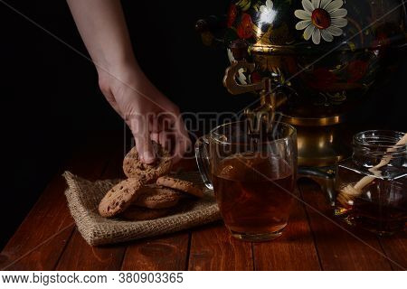A Girl With Cookie In Hand. Samovar
A Jar With Tea, Honey And Cookies.