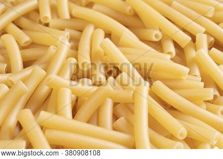 Macro Shot Pasta Noodles Texture. Macaroni Background Pattern. Top View. Dry Pasta For Cooking. Abst