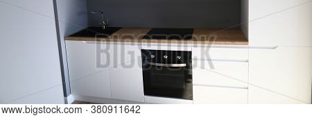 Closeup Of Kitchen Interior In New Apartment. Small And Compact Furniture For Flat. Modern Black Coo